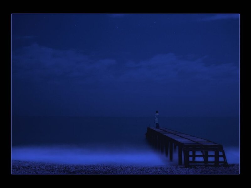 Person on a pier at night