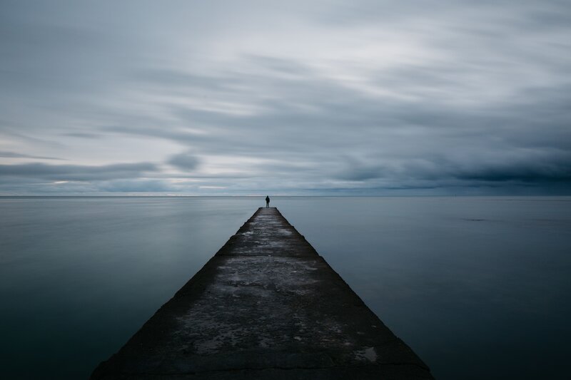 Person on a pier at sea
