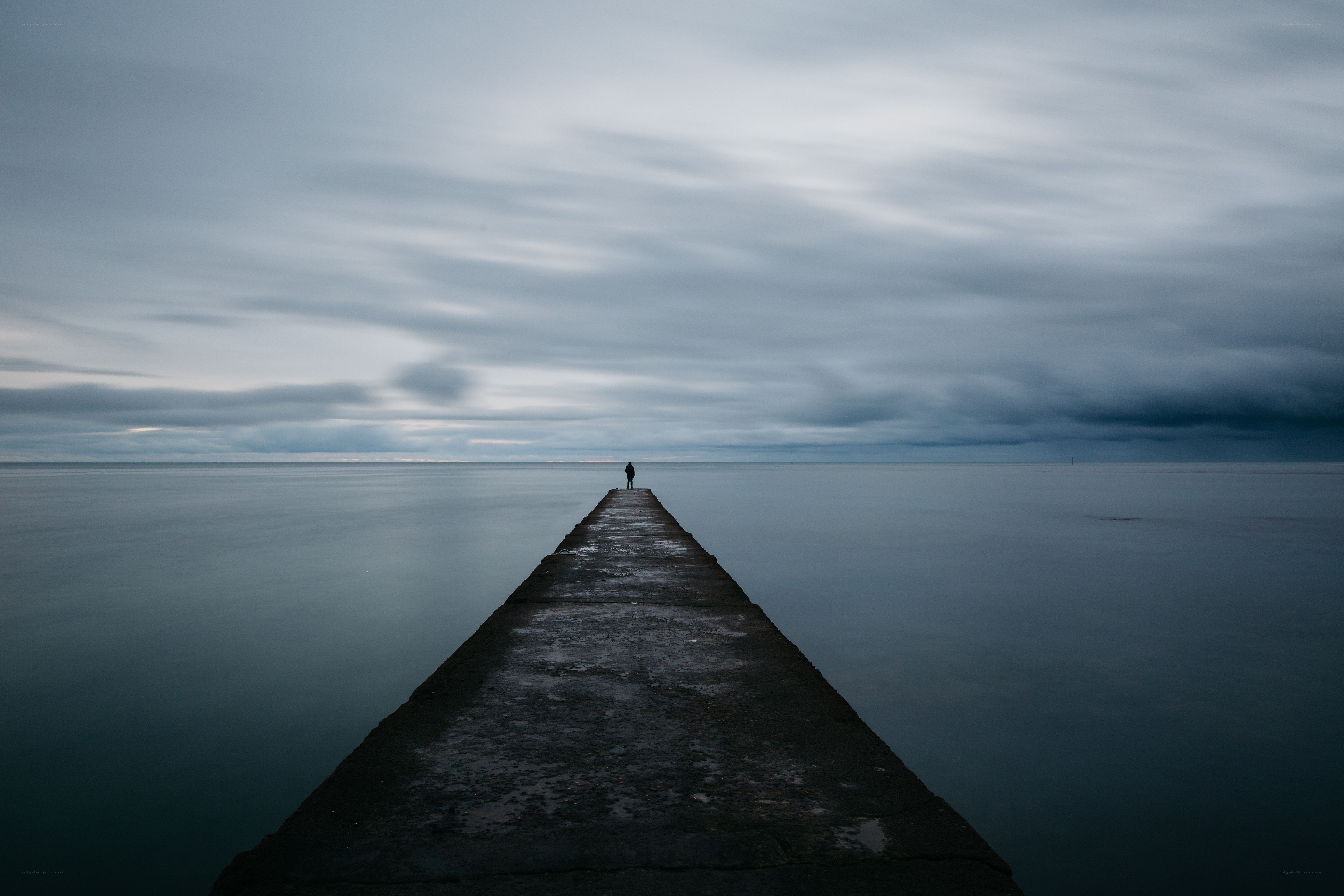 Person on a pier at sea