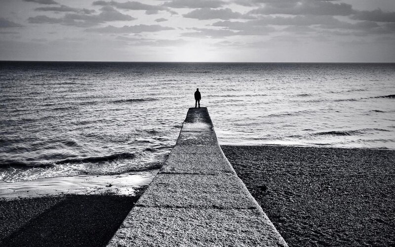 Person on a pier at the ocean