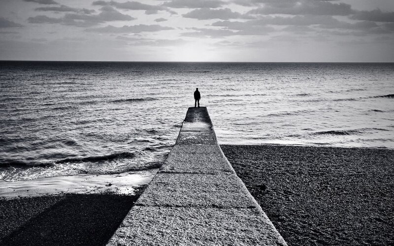 Person on a pier at the sea