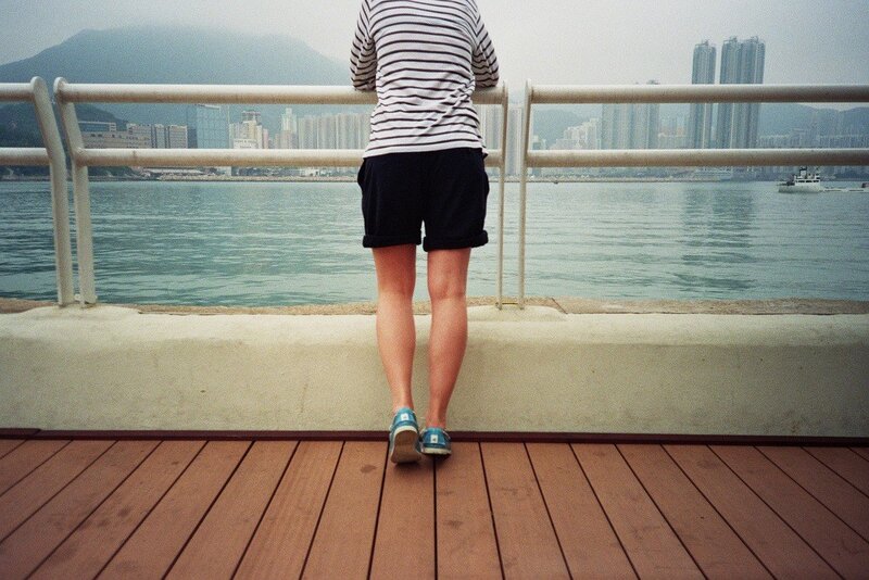 Person on a pier overlooking the city
