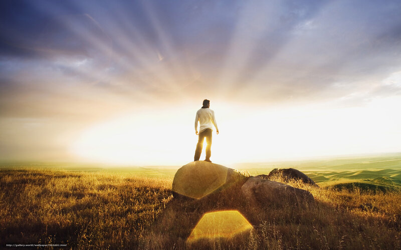 Person on a rock at sunrise