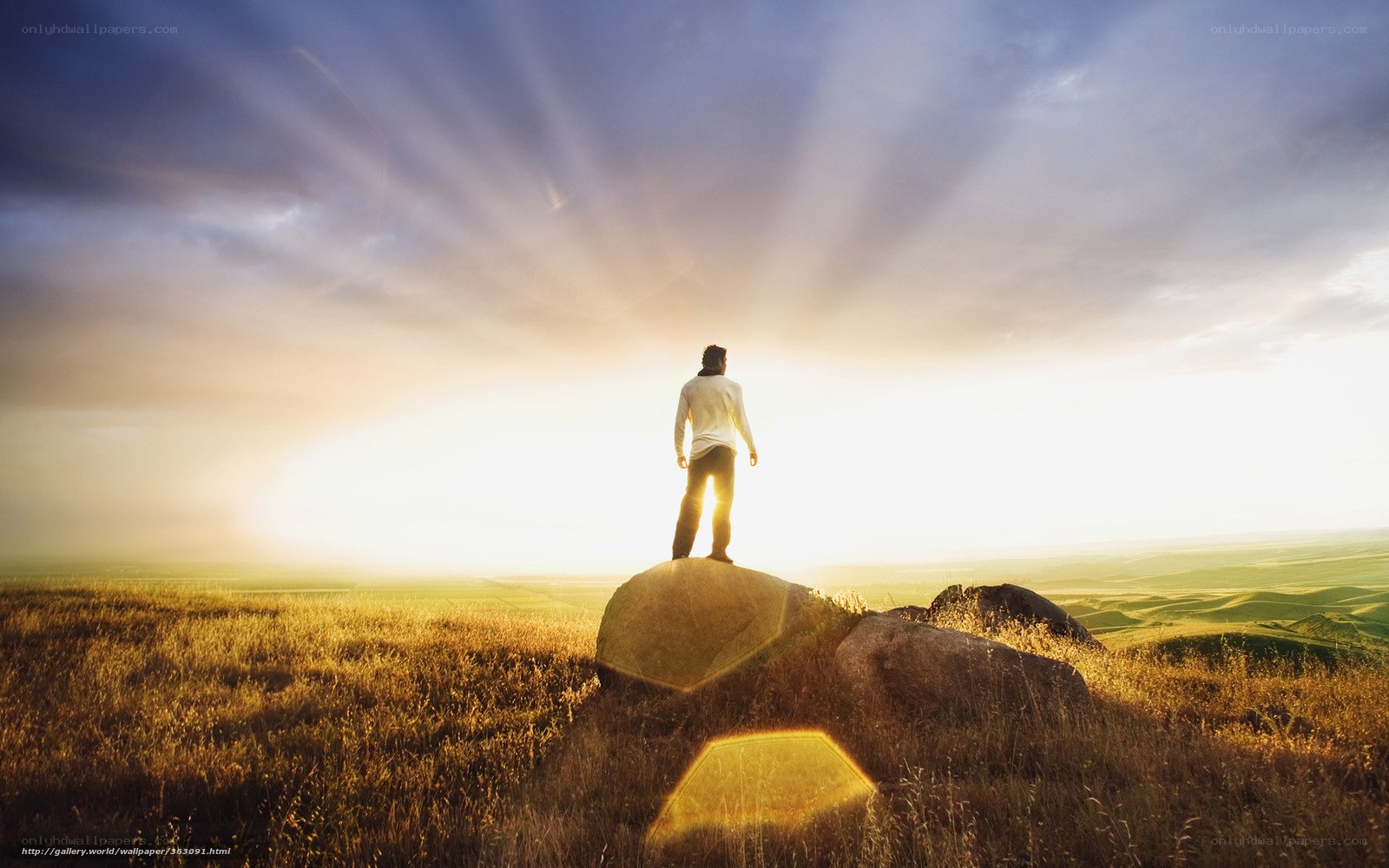 Person on a rock at sunrise