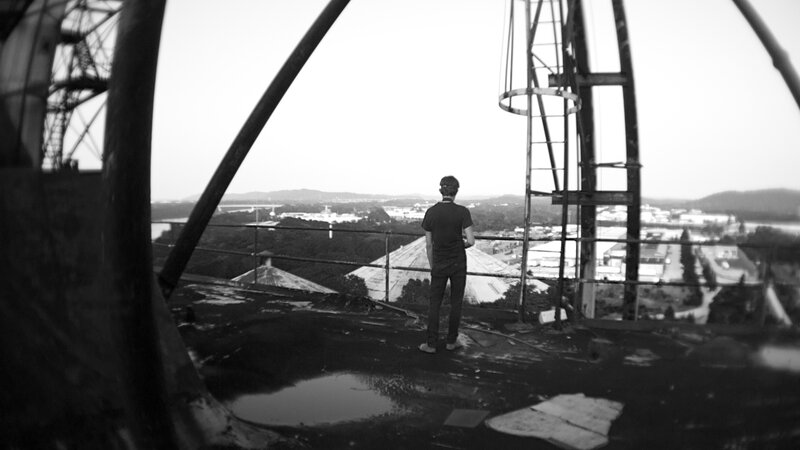 person on a rooftop overlooking city