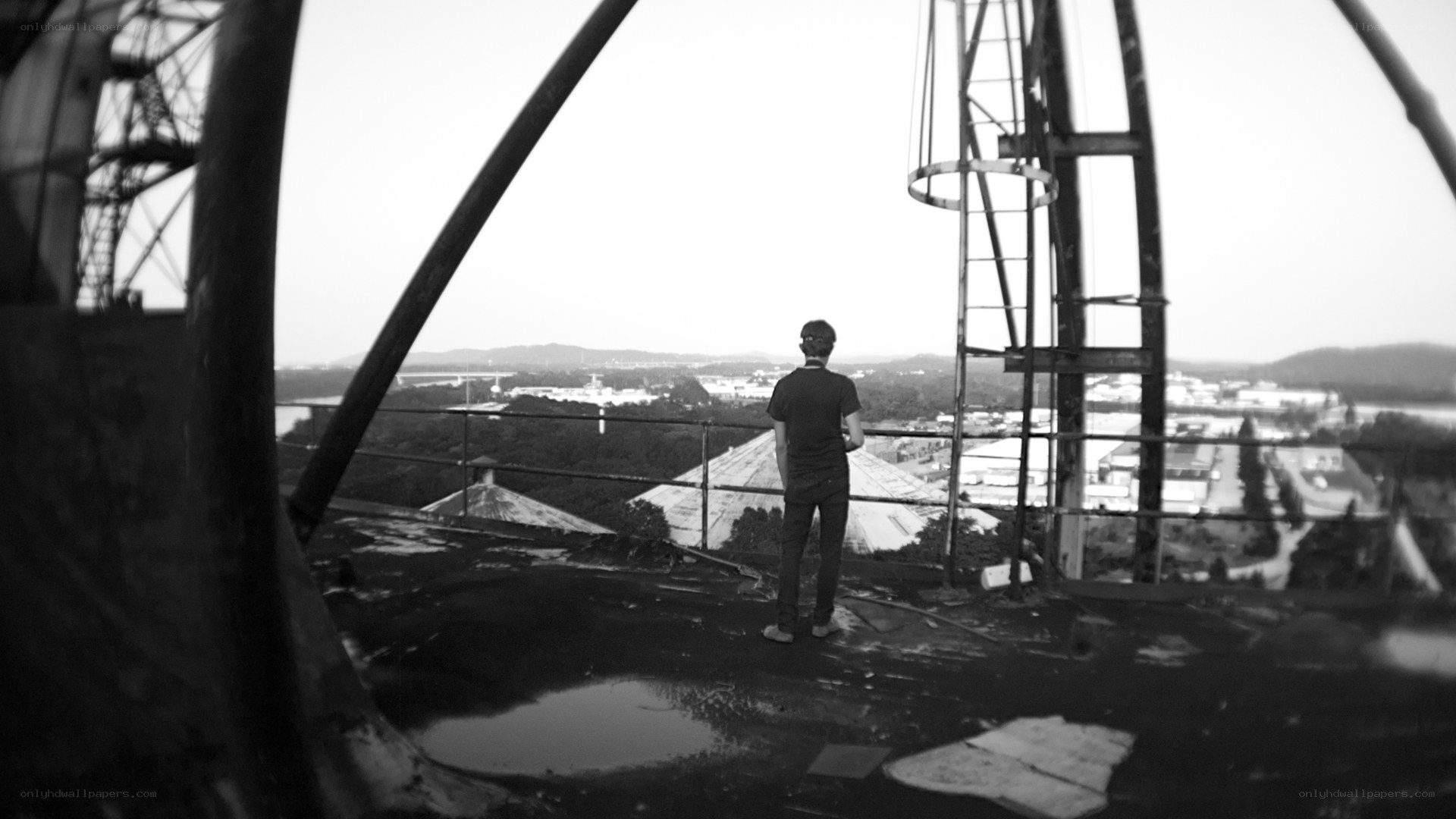 person on a rooftop overlooking city