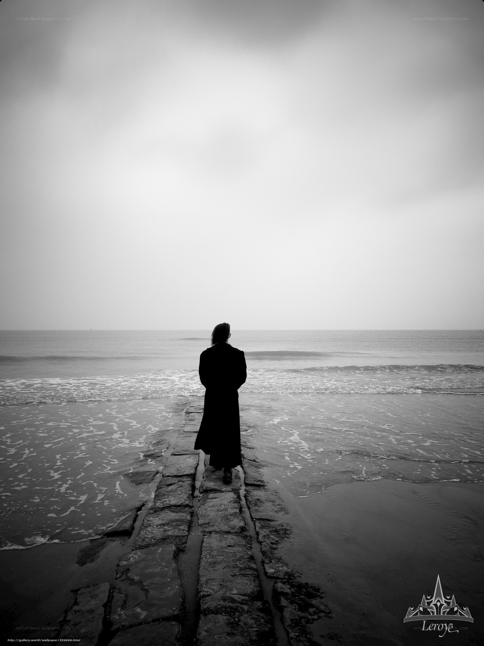 Person on a stone path at the beach