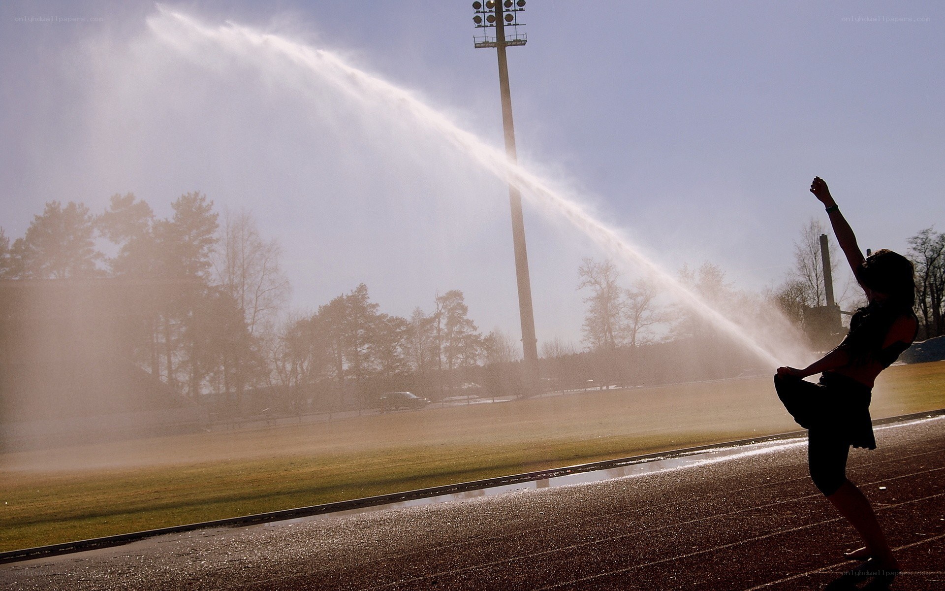Person on a track with sprinkler