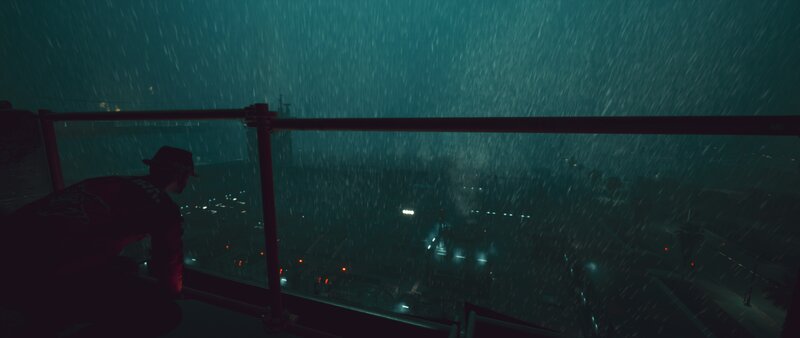 Person on Balcony in Rain