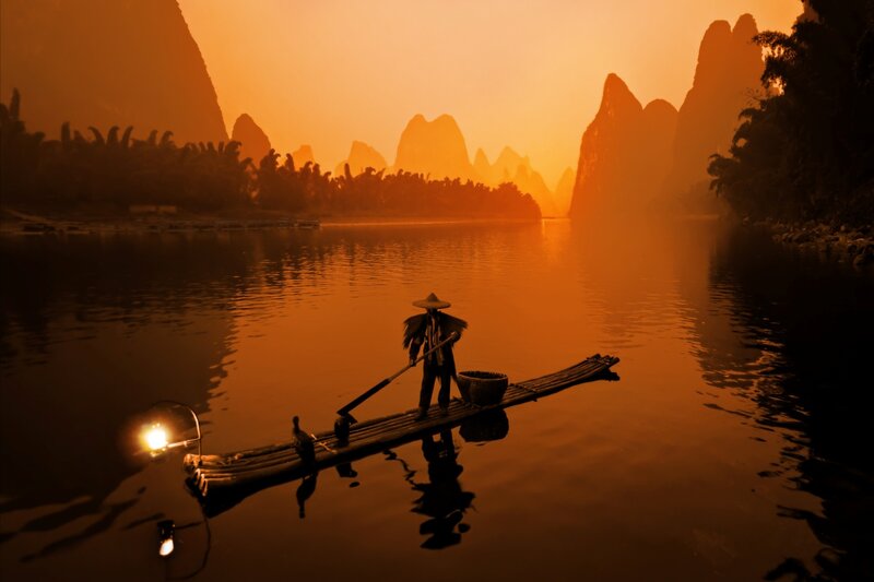 Person on Bamboo Raft — Orange