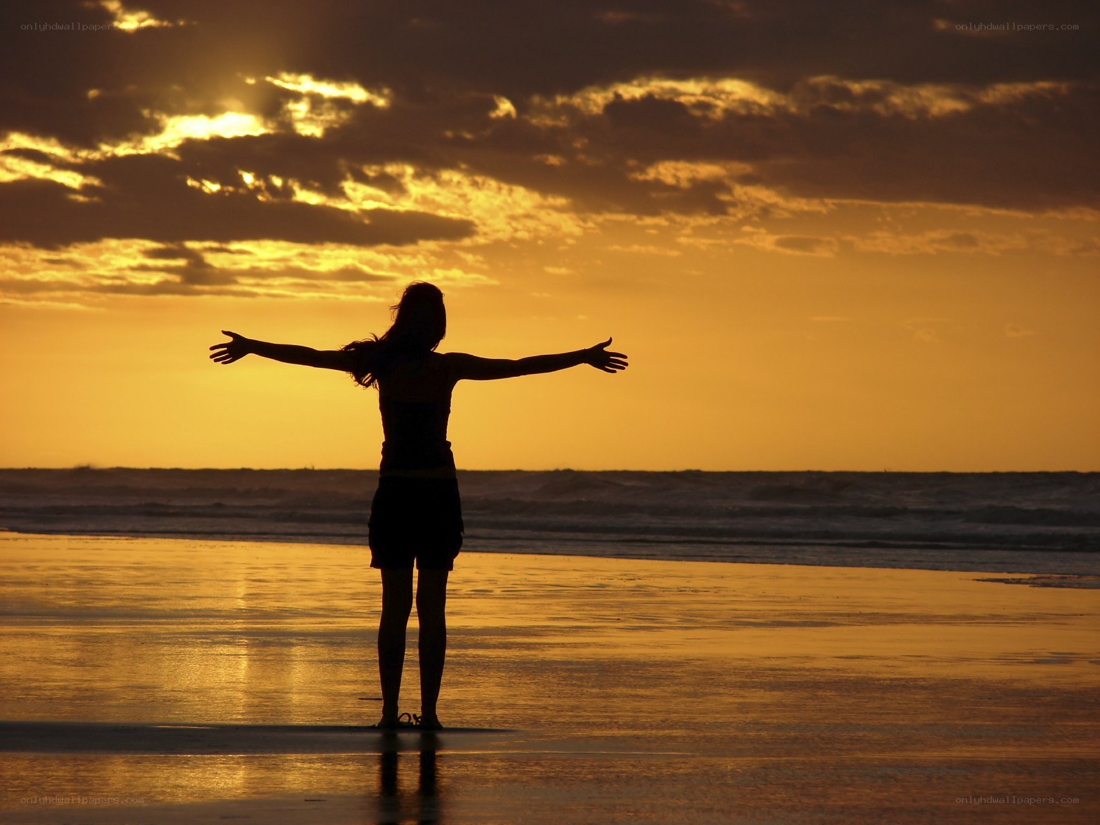Person on beach at sunset