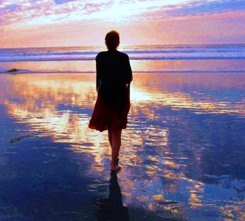 Person on beach at sunset