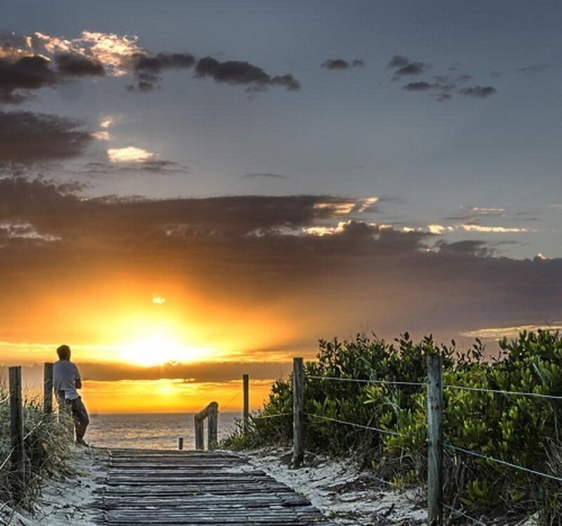 Person on Beach at Sunset — Orange, Serene, Photograph, Boardwalk