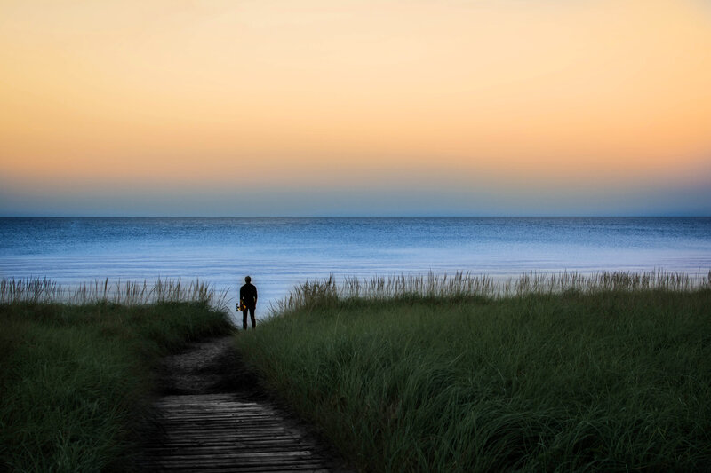 Person on Beach at Sunset — Orange, Serene, Photograph, Ocean