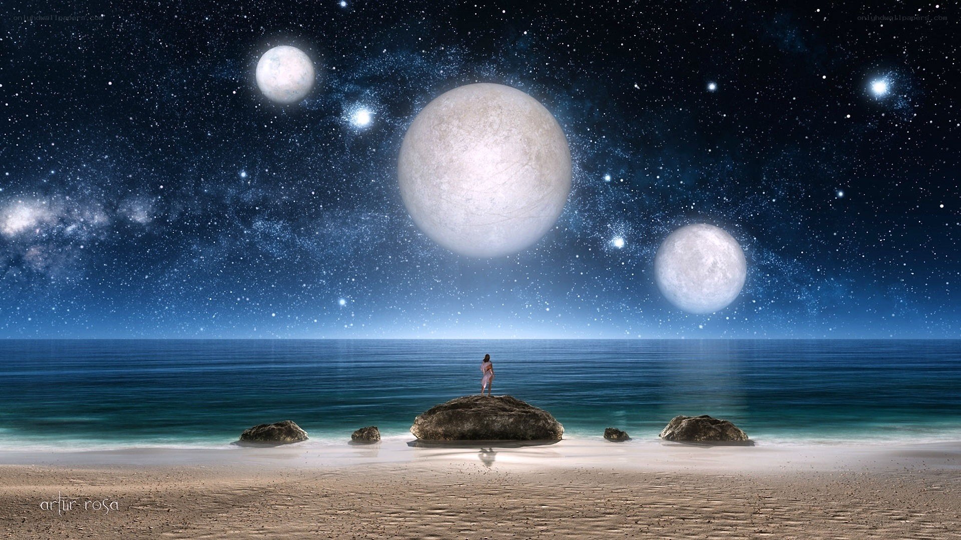 Person on beach with multiple moons