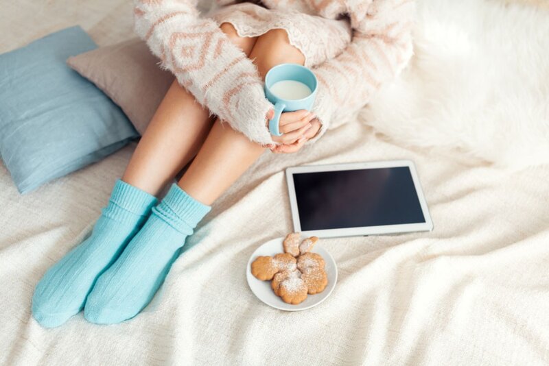 Person on Bed with Mug