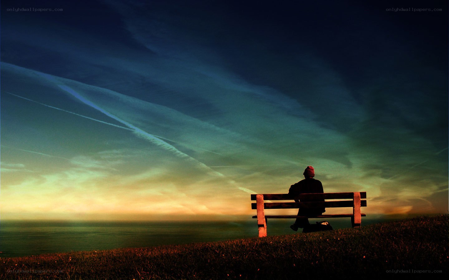 Person on bench at sunset