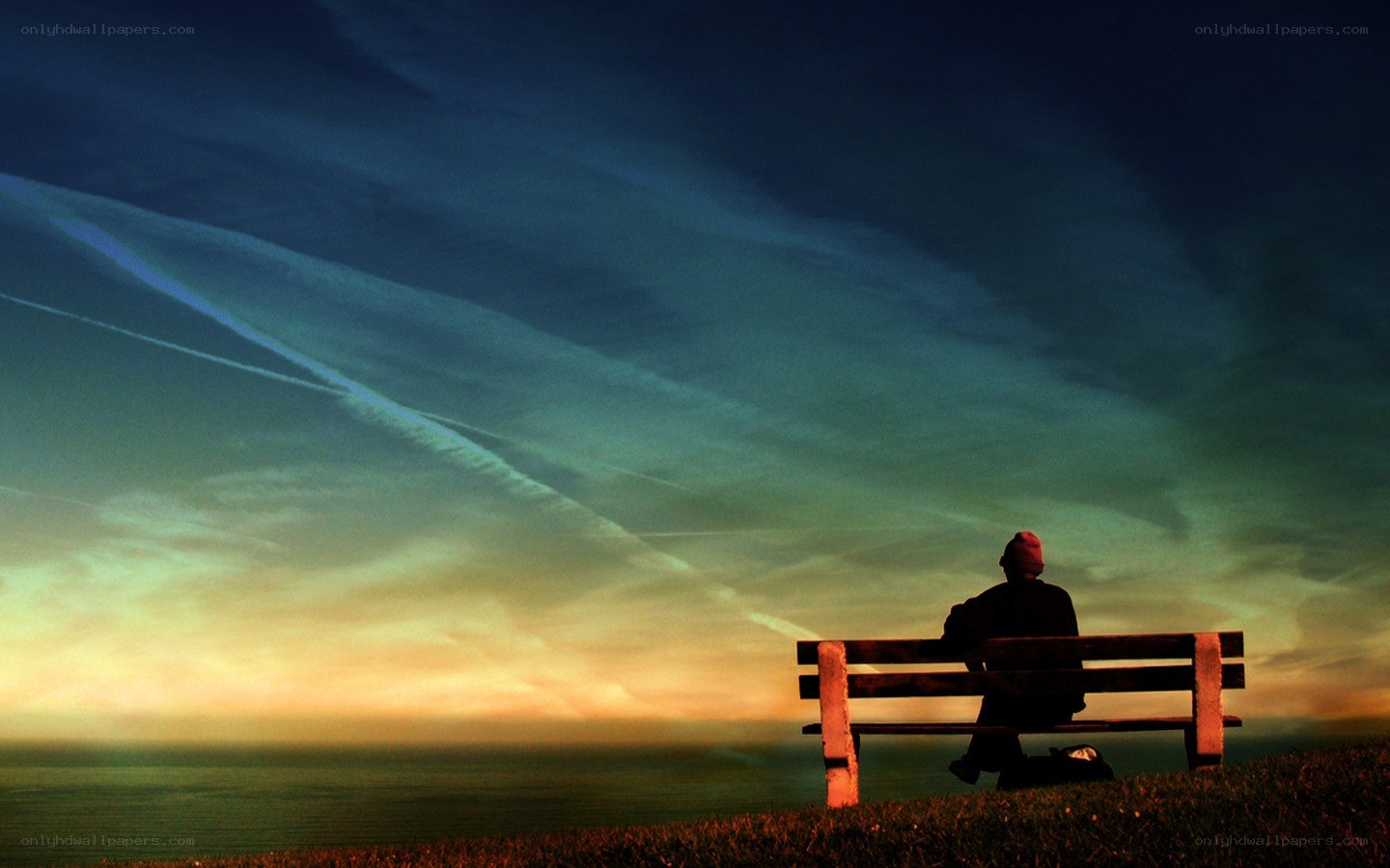 Person on bench at sunset