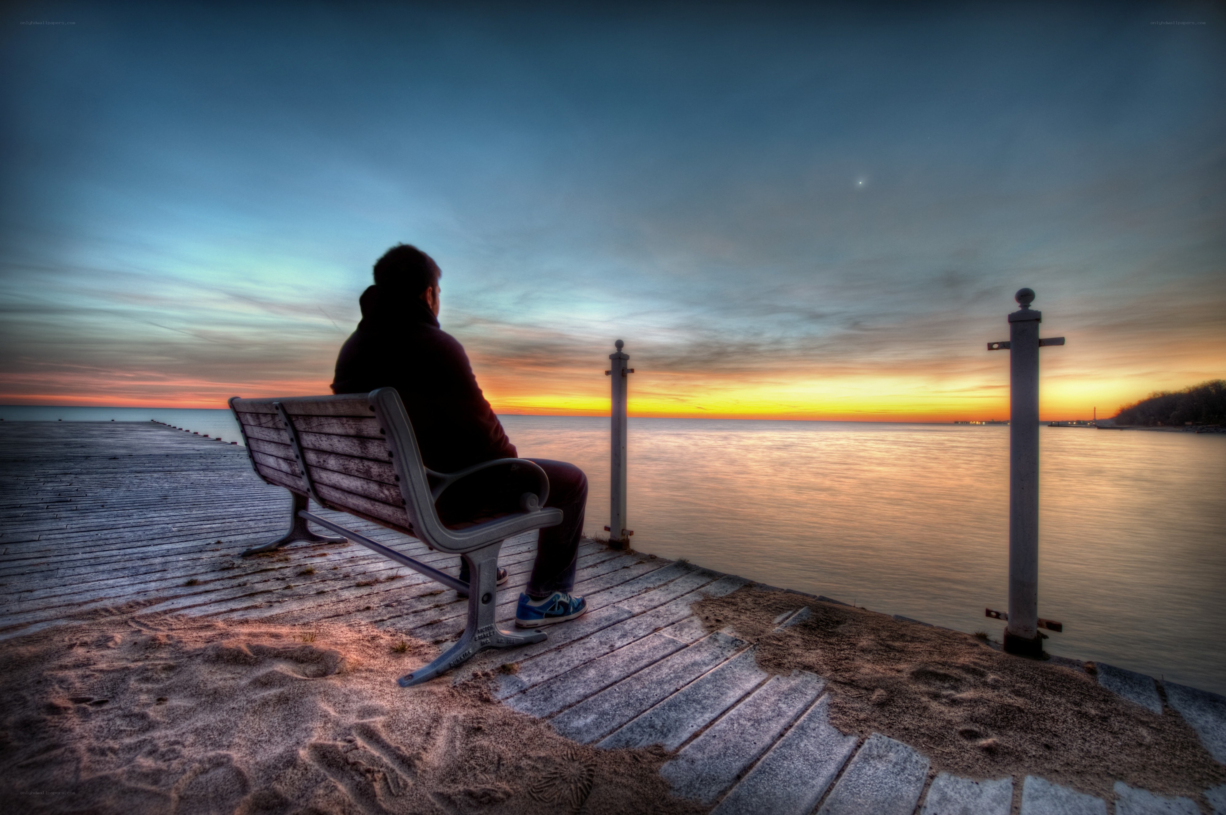Person on bench at sunset