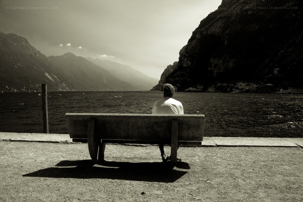 Person on bench by lake