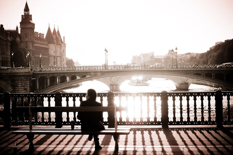 Person on bench by river
