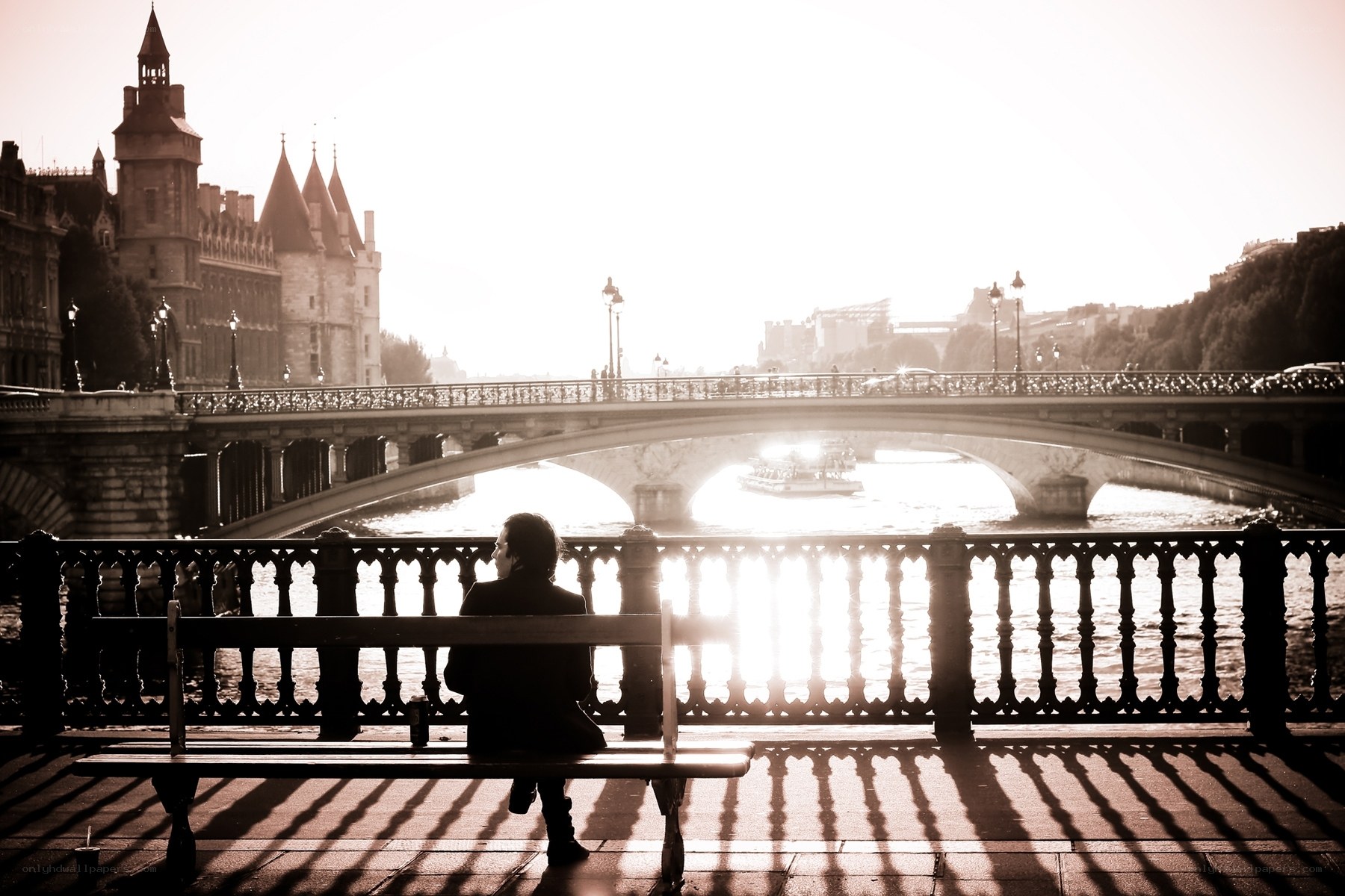 Person on bench by river