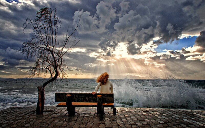 Person on Bench by Sea