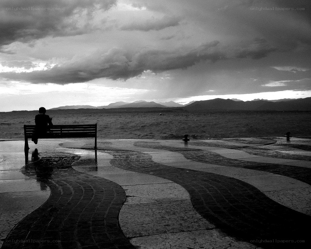 Person on bench by the sea