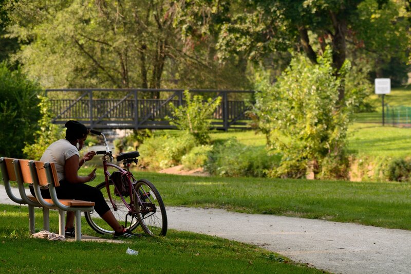Person on Bench with Bicycle