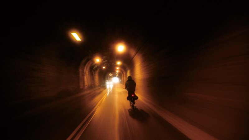 Person on Bicycle in Tunnel