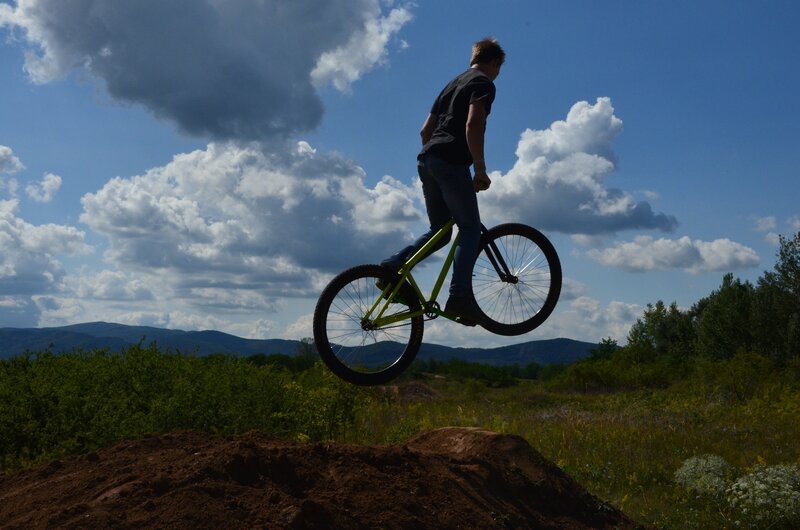 Person on Bicycle Mid-air — Blue, Dramatic