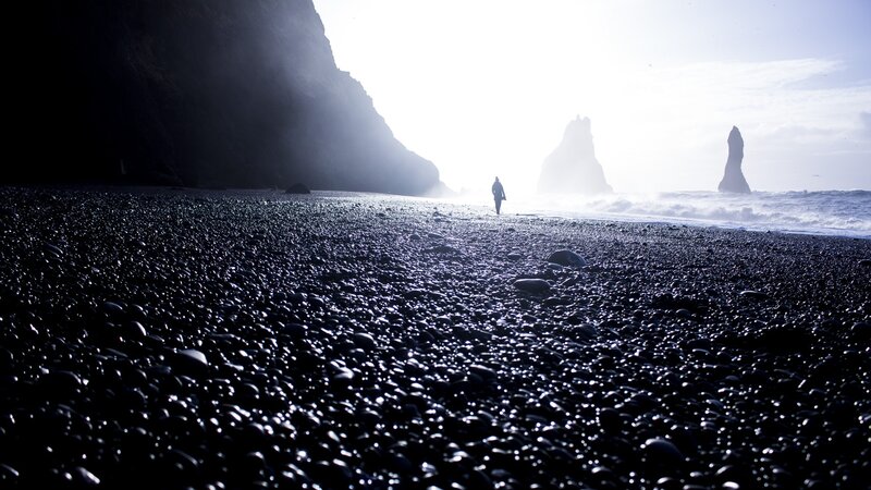 Person on Black Sand Beach — Dramatic