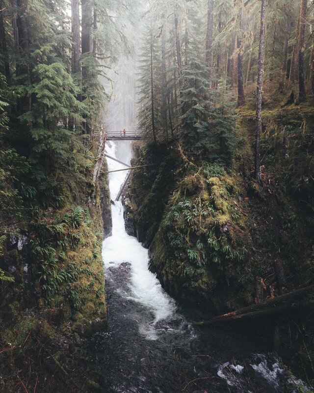 Person on Bridge over Waterfall