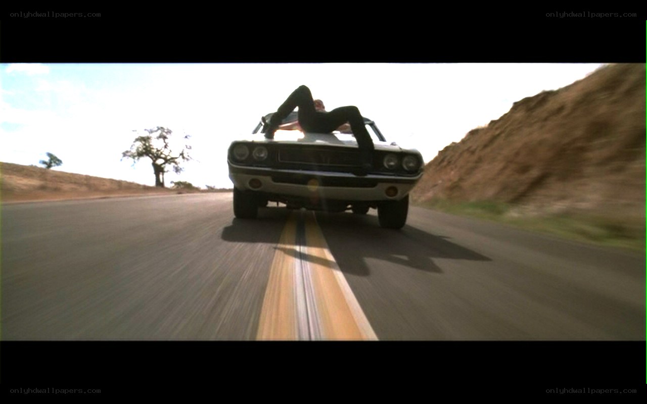 person on car hood driving