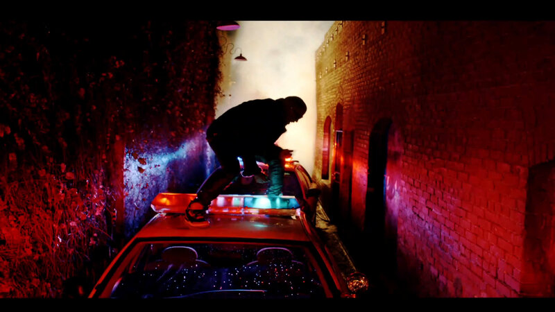 person on car roof at night