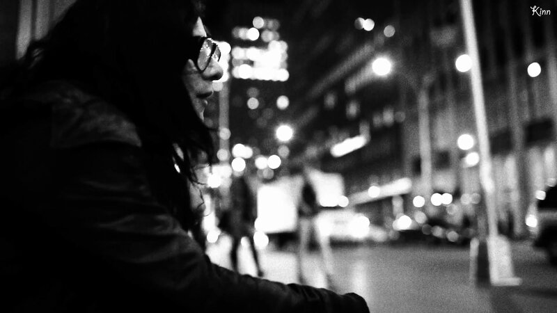 person on city street at night
