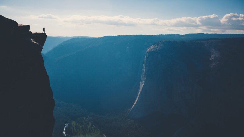 Person on Cliff Edge — Blue, Dramatic, Afternoon, Photograph, Mountain, Forest