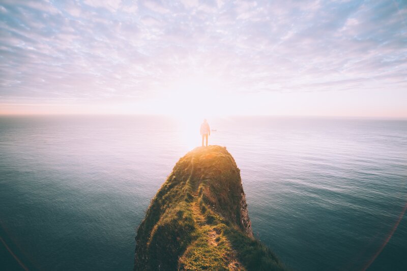 Person on Cliff Edge — Blue, Serene, Sunset, Photograph