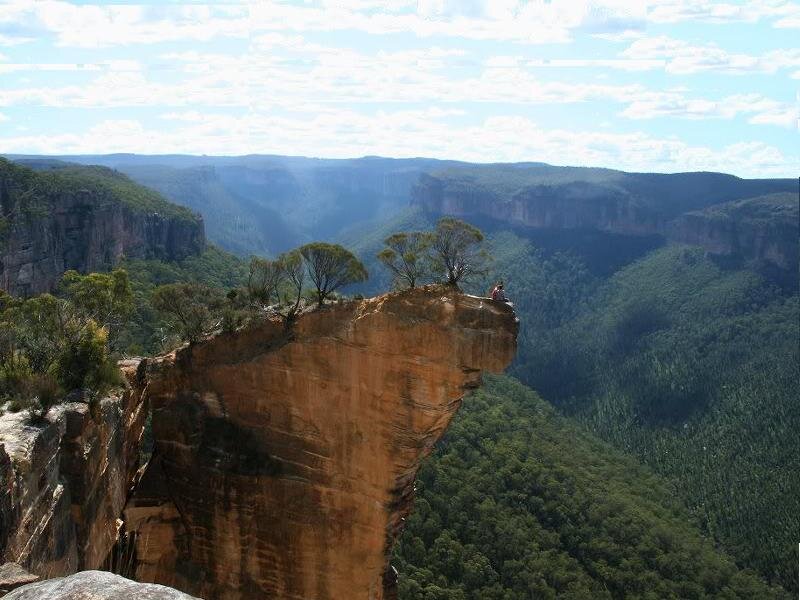 Person on Cliff Edge — Brown, Serene