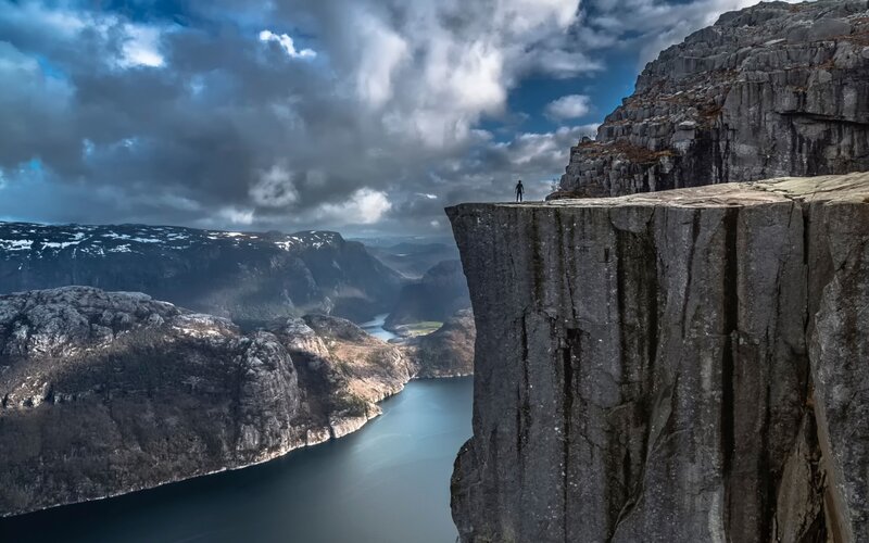 Person on Cliff Edge — Gray, Dramatic, Afternoon, Photograph, Fjord