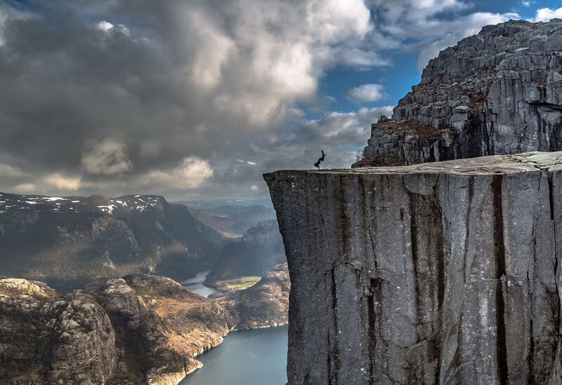 Person on Cliff Edge — Gray, Dramatic, Afternoon, Photograph, Mountains