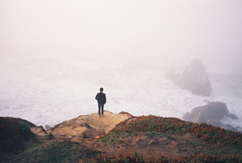 Person on Cliff Edge — Gray, Misty