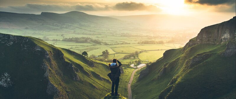 Person on Cliff Edge — Green, Serene, Sunrise