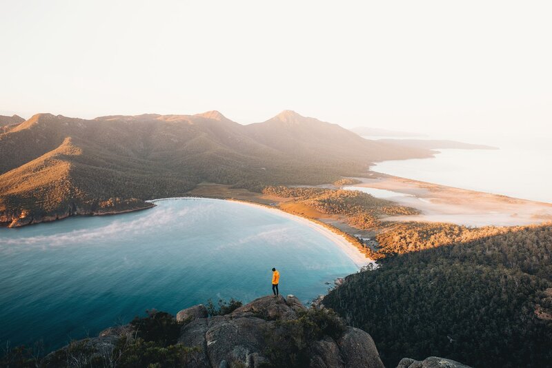 Person on Cliff Overlooking Bay