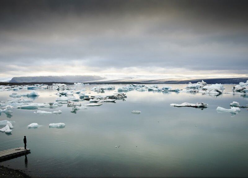 Person on Dock by Icebergs