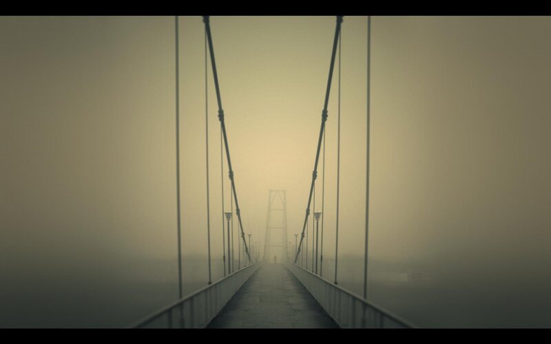 Person on Foggy Bridge