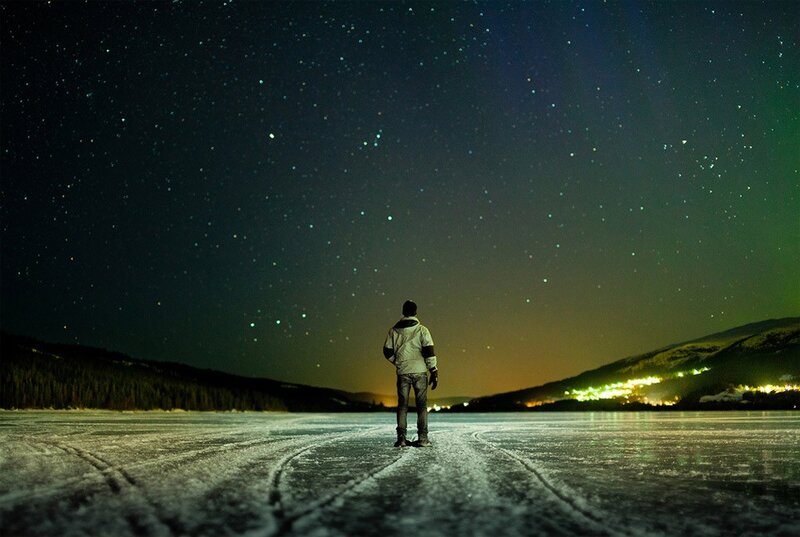 person on frozen lake at night