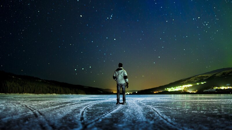 Person on frozen lake at night