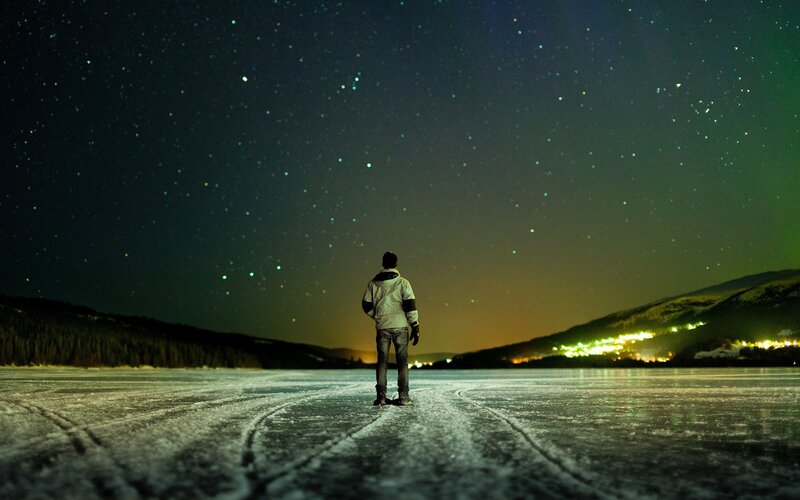 Person on frozen lake at night