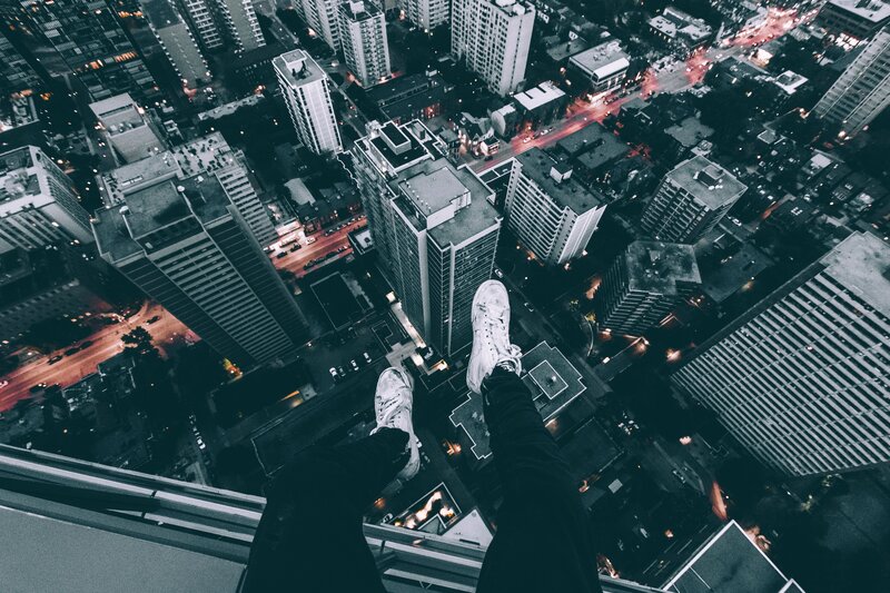person on high building edge